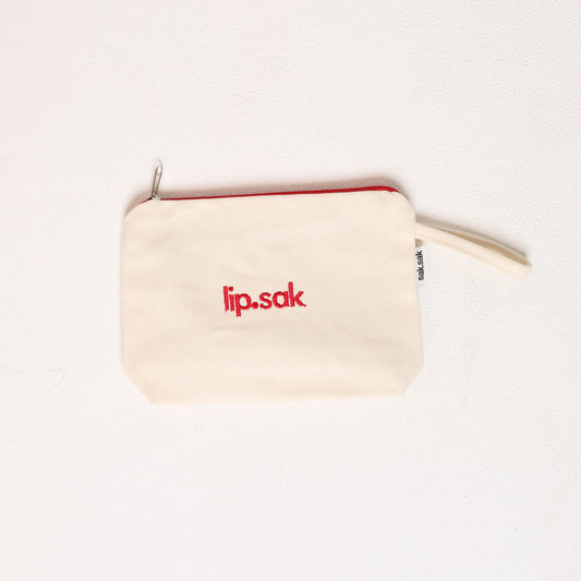 Small beige pouch with 'lip.sak' logo on a white background