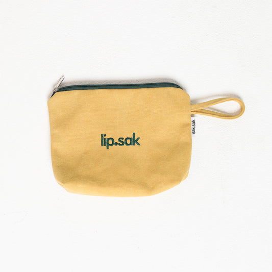 Yellow pouch with 'lip.sak' branding on a white background