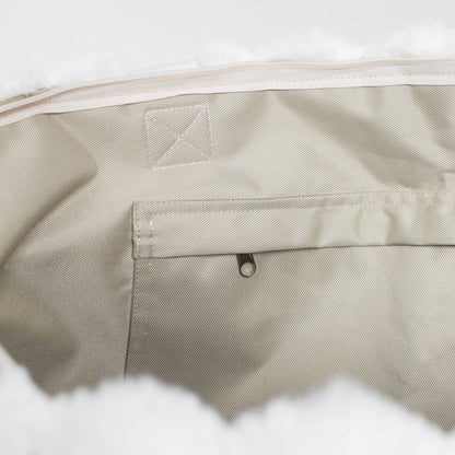 Close-up of beige fabric with a brand logo on a white background