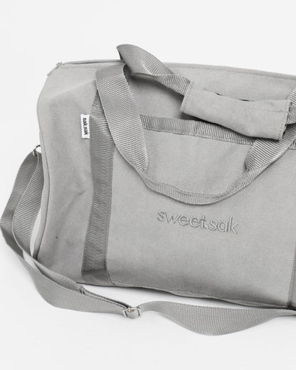 Gray duffel bag with 'sweetsak' branding on a white background